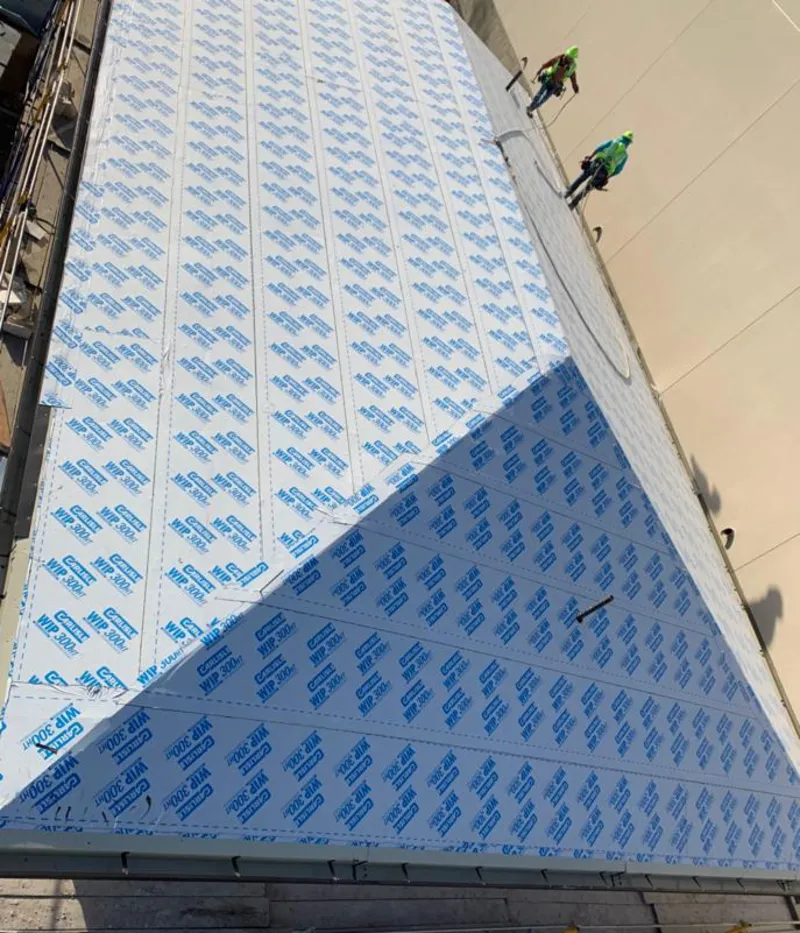 Professional roofers installing underlayment on a metal roof in Elizabethtown